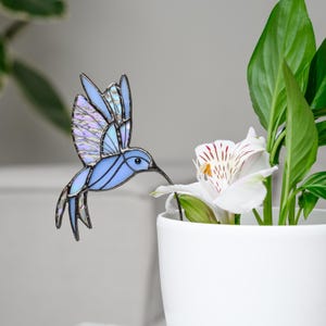 May include: A set of three ceramic mugs with a speckled, matte finish. Each mug features a different color: light blue, cream, and gray. The mugs have a simple, modern design and a comfortable handle.