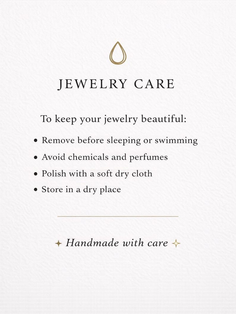 May include: A white informational card titled JEWELRY CARE with a gold droplet icon. It lists instructions: remove before sleeping or swimming, avoid chemicals and perfumes, polish with a soft dry cloth, and store in a dry place. Ends with Handmade with care.