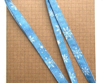 Snowflakes on blue fabric lanyard