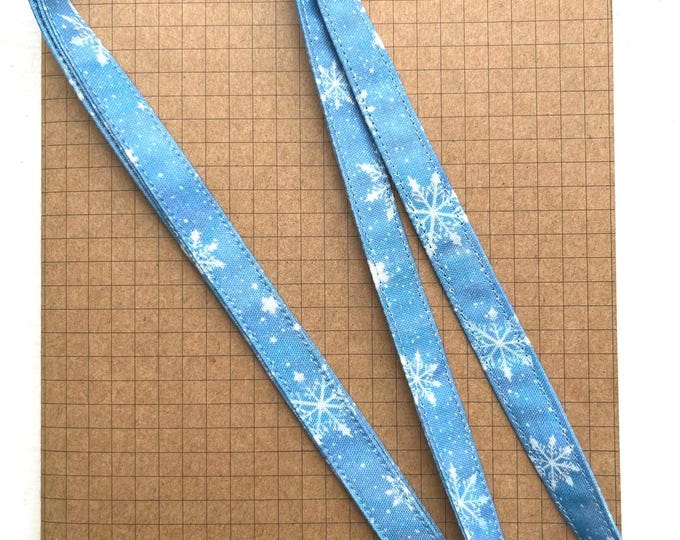 Snowflakes on blue fabric lanyard