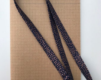 Metallic copper spot on navy fabric lanyard