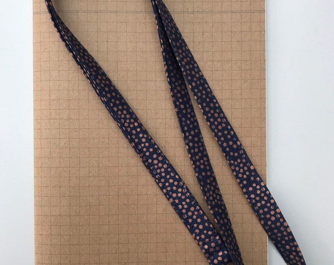 Metallic copper spot on navy fabric lanyard