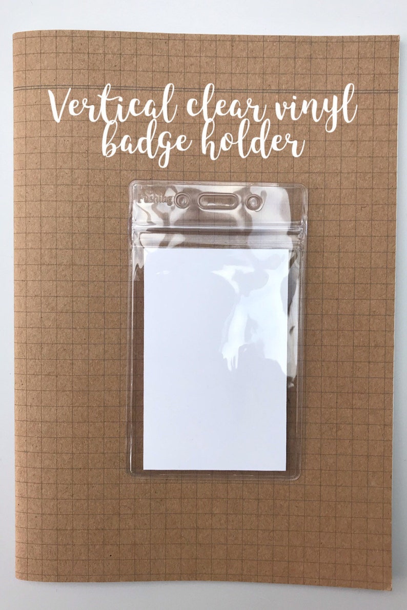 May include: A vertical clear vinyl badge holder on a brown gridded background. The holder has two eyelets at the top and a clear plastic flap that closes with a zipper.