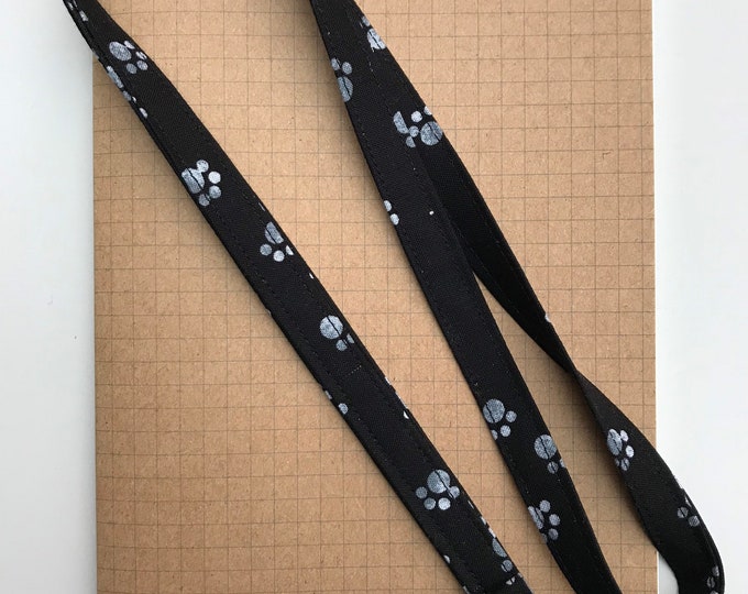 Black and white paw print fabric lanyard