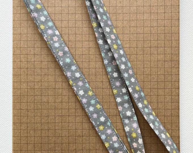 Pastel flowers on grey fabric lanyard