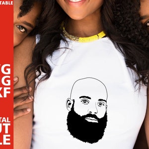 May include: A woman wearing a white shirt with a black and white line drawing of a man with a beard on the front.