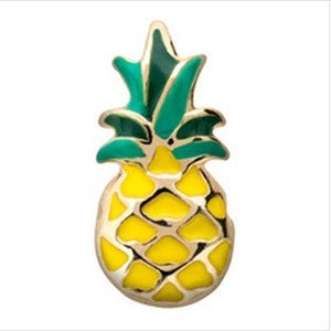 May include: A gold-colored pineapple charm with a yellow body and green leaves.