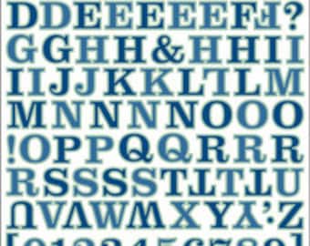May include: A sheet of blue and white alphabet stickers with a yellow outline. The stickers include uppercase letters, numbers, and punctuation marks.
