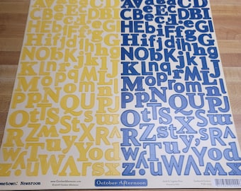 May include: Two sheets of alphabet stickers, one sheet with yellow letters on a white background and the other sheet with blue letters on a white background. The sheets are labeled "October Afternoon" and "Newsroom".