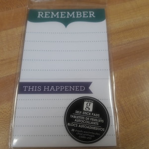 May include: A white notepad with green and purple accents. The notepad has the words "Remember" and "This Happened" printed on it. The notepad is packaged in a clear plastic sleeve. The notepad is a self-stick pad with 20 sheets per pad.