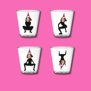 May include: Four clear plastic shot glasses with a black silhouette of a person in a party hat. Each glass has a different pose of the silhouette.