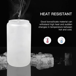 May include: A frosted glass bottle with a wide mouth, designed to withstand high temperatures. The bottle is shown with steam rising from it, and ice cubes are in the background. The text "HEAT RESISTANT" is displayed above the bottle, along with a description of the bottle's heat-resistant properties.