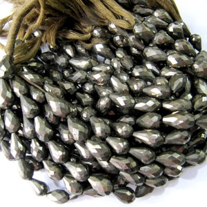 May include: A strand of faceted pyrite beads in a teardrop shape. The beads are a dark, metallic grey colour with a slight sheen.