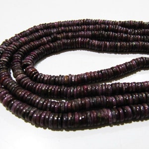 May include: A strand of purple gemstone beads, each bead is a flat, round disc with a slightly irregular shape.