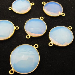May include: Six round, white opal gemstone connector charms with gold-toned metal settings. Each charm has two loops for attaching to jewelry.