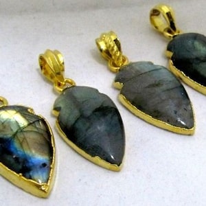 May include: Four gold-plated pendants with iridescent labradorite stones in a teardrop shape. The stones have a dark blue, green, and gray color.
