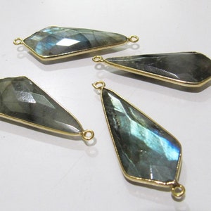 May include: Four gold-plated labradorite gemstone pendants with two jump rings on each. The pendants are in the shape of a teardrop with a pointed end.