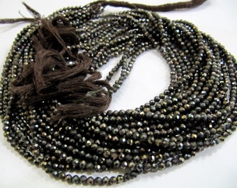 May include: A strand of dark brown faceted gemstone beads. The beads are small and have a shiny, metallic finish.