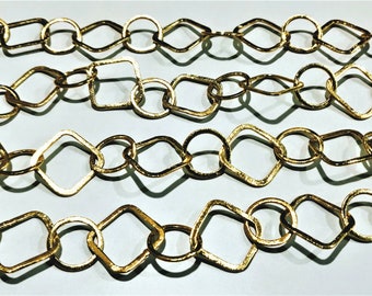 May include: A gold chain with square and round links. The chain is made of metal and has a shiny finish.