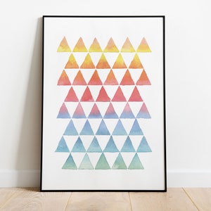 May include: A framed print featuring a geometric pattern of watercolour triangles in shades of yellow, orange, red, pink, blue, and green.
