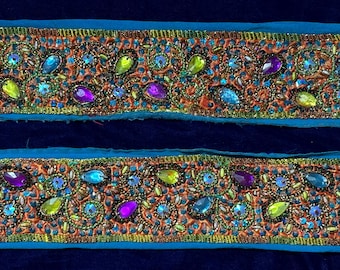 May include: Two rows of blue and orange trim with colorful beaded embellishments. The trim is decorated with sequins, beads, and rhinestones.