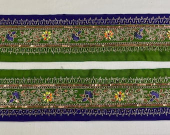 May include: Two strips of green fabric trim with gold and silver sequins, embroidered with floral designs in shades of green, blue, orange, and yellow.