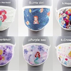 May include: Set of 10 colorful fabric face masks featuring various Disney characters, including Ariel, Rapunzel, Snow White, and Elsa. Each mask has a white border and a different design.