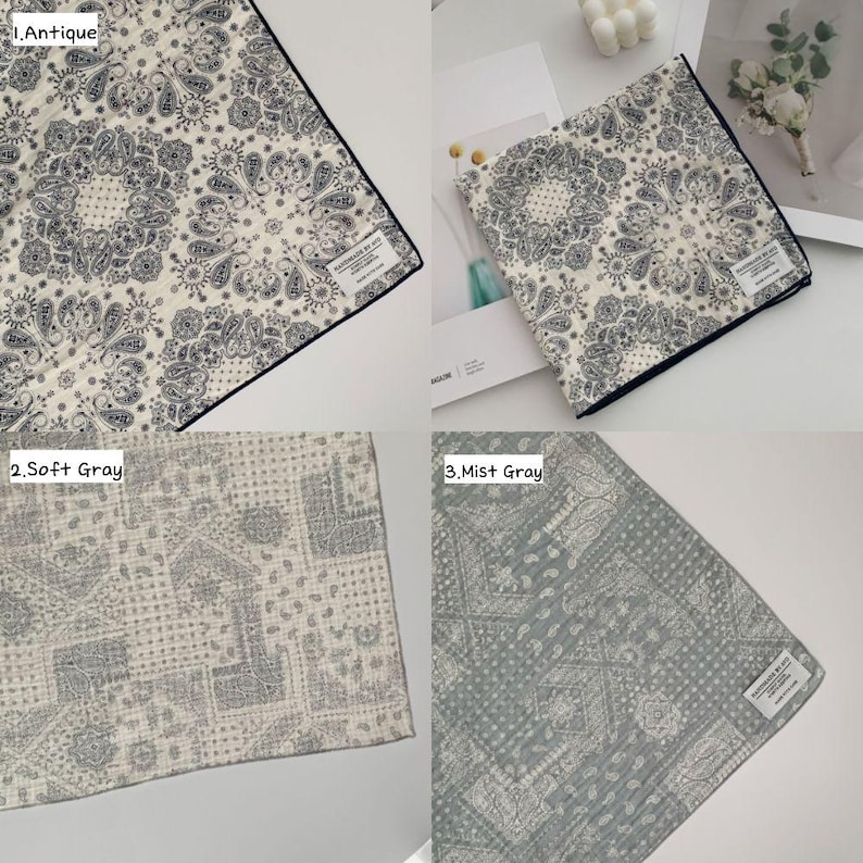 May include: A collection of three square fabric handkerchiefs featuring intricate paisley and mandala-inspired patterns. The first is cream with dark gray details, the second is light gray, and the third is a muted mist gray, each with a small white label.