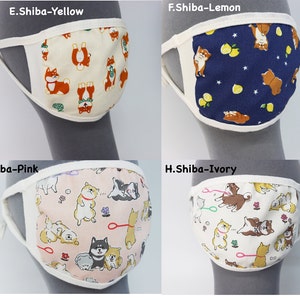 Op de afbeelding: Vier stoffen gezichtsmaskers met Shiba Inu hondenpatronen. E.Shiba-Yellow heeft een cr&egrave;mekleurige achtergrond, F.Shiba-Lemon een donkerblauwe achtergrond met citroenen, G.Shiba-Pink een lichtroze achtergrond en H.Shiba-Ivory een ivoorkleurige achtergrond.