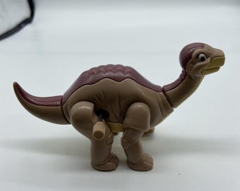 Figura de juguete de cuerda de Littlefoot de Burger King, modelo de 1997, de la película "En busca del valle encantado", con forma de dinosaurio.
