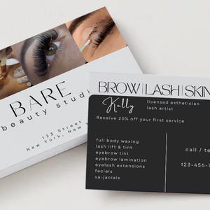 May include: Business cards for a beauty studio, featuring a close-up of an eye with long eyelashes. The cards display the studio's name, address, and services, including waxing, lash lifts, and facials. One card is black with white text, and the other is white with black text.