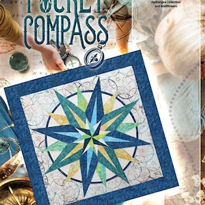 May include: A blue and green quilt block with a compass star design. The block is surrounded by a blue border and a white background with a map-like pattern. The text "Pocket Compass" is in the upper left corner of the image. The text "Timeless Treasures Hydrangea Collection and Wallflowers" is in the upper right corner of the image. The text "Quiltworx.com Foundation Paper Piecing" is in the lower right corner of the image.