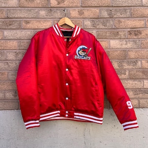 May include: Red satin baseball jacket with white stripes on the sleeves and collar. The jacket has a Baycats logo on the left chest and the number 9 on the right sleeve.