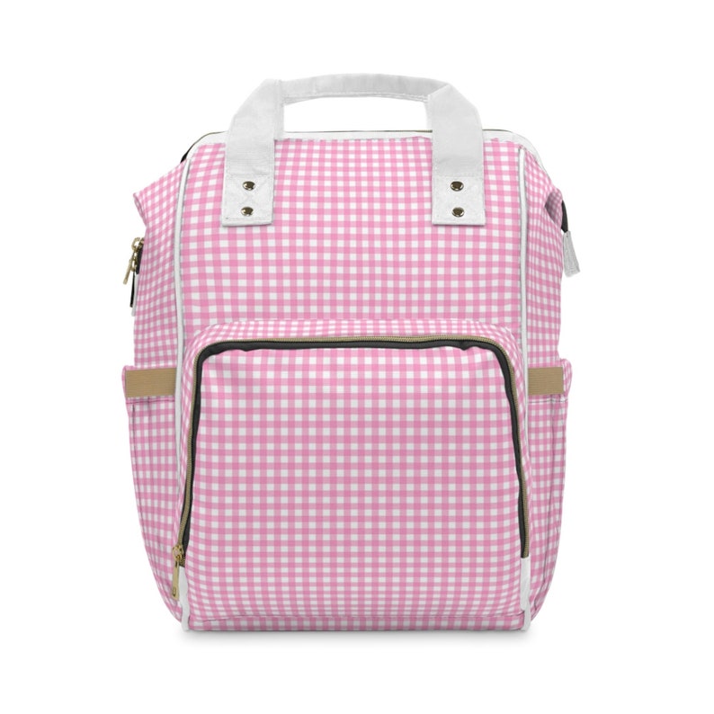 K&ouml;nnte beinhalten: Rosa-wei&szlig;e Gingham-Wickeltasche mit gro&szlig;em Frontfach und zwei Seitentaschen.