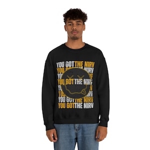 May include: Black sweatshirt with a yellow smiley face and the text "YOU GOT THE NIRV" repeated in a pattern.