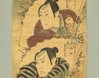 May include: Antique Japanese woodblock print featuring two figures with stern expressions, each holding a fan. The figures are depicted against a backdrop of floral patterns and text. The print has a vintage, aged appearance.