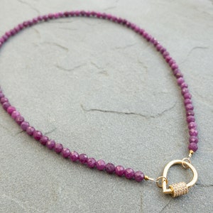 Faceted 4mm ruby gemstone bead necklace in deep pink and red hues, finished with a gold tear-drop shaped clasp with pavé detail, elegant handmade jewelry gift for her.