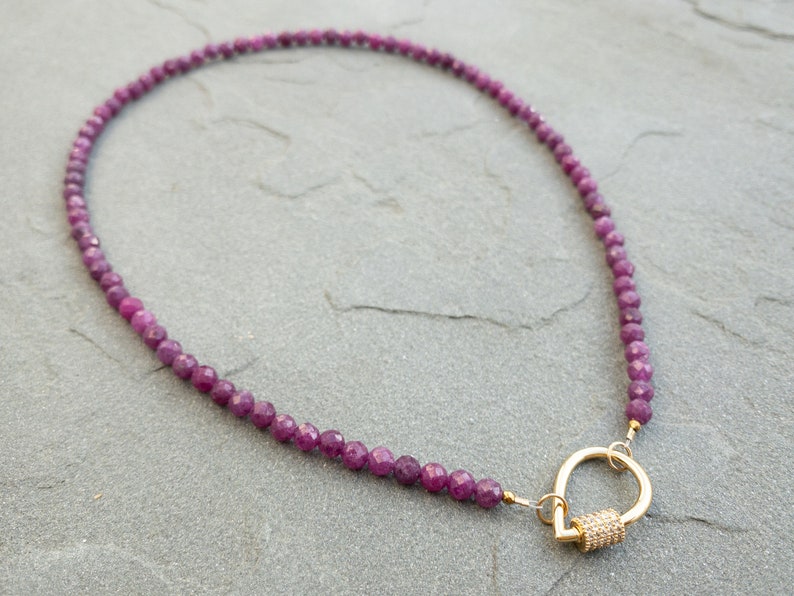 Faceted 4mm ruby gemstone bead necklace in deep pink and red hues, finished with a gold tear-drop shaped clasp with pavé detail, elegant handmade jewelry gift for her.