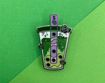 May include: A green, purple, and white enamel pin of a boba tea cup with tapioca pearls, a straw, and a flower on top. The pin has a shiny silver finish.