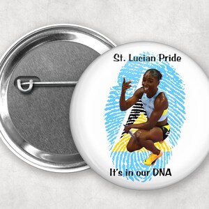May include: A white button with a blue and yellow fingerprint design. The text "St. Lucian Pride" and "It's in our DNA" is printed on the button. A woman athlete is pictured inside the fingerprint.