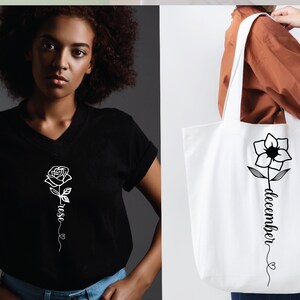 May include: A black t-shirt with a white outline of a rose and the word "rose" written vertically along the stem. A white tote bag with a black outline of a flower and the word "december" written vertically along the stem.