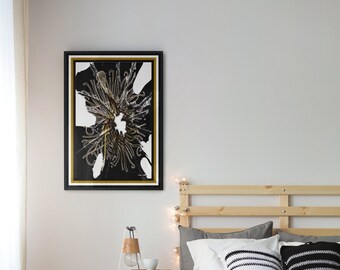 May include: Black and white framed print of a stylized floral design with gold accents. The print is hanging on a white wall above a wooden bed frame.