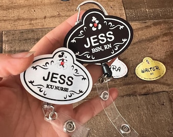 May include: A collection of Disney-themed name badges and badge reels. The badges feature the Mickey Mouse silhouette and the names "JESS", "MARIAH", and "WALTER". The badge reels are black and white with decorative swirls and the text "ICU NURSE" and "BSN, RN".