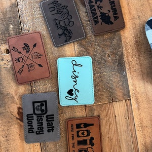 May include: Six brown leather patches with various Disney-themed designs, including "Hakuna Matata", "Walt Disney World", "Disney", and "Here for the Drinks".