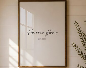 May include: A rectangular wall art print in a thin brown wooden frame featuring a white background with the black text Harringtons and the smaller text EST. 2028 centered below it in a simple, clean, and legible font style.