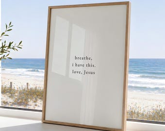 May include: A rectangular wall art print in a light wood frame featuring a white background with black text that reads: breathe, i have this. love, Jesus. The print is positioned upright, displaying a clean, simple design with clear lettering.