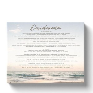 May include: A canvas print featuring the text "Desiderata" in elegant script. The poem's verses are printed in a classic font against a backdrop of a beach scene with the ocean and sky. The artwork is framed.