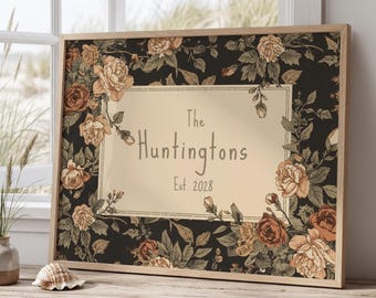 May include: A rectangular framed wall art piece featuring a dark background with a floral pattern of roses in shades of peach, tan, and brown. A central cream-colored rectangular panel displays the text The Huntingtons Est. 2028 in dark font.