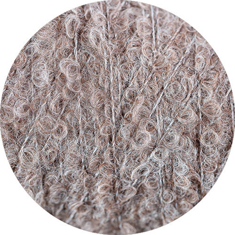May include: Close-up of a skein of brown and white yarn with a fuzzy texture.