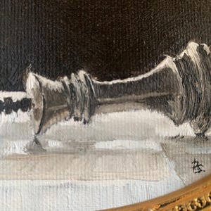May include: An oil painting on canvas depicting a fallen silver chess king piece lying horizontally on a checkered surface. The background is a solid dark black, and the piece features visible brushstrokes in shades of silver, gray, and white.